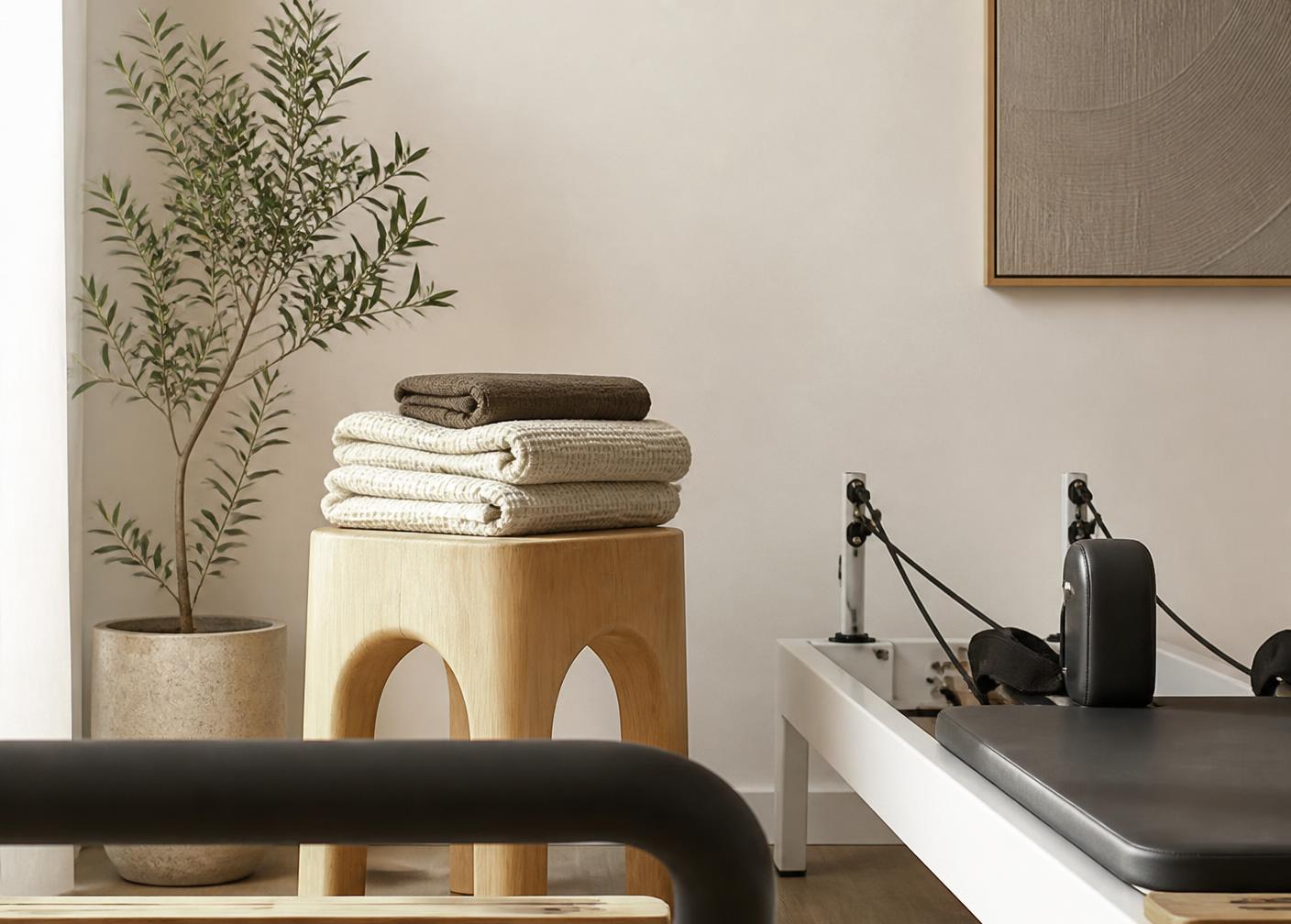 A quiet corner of the studio with folded towels and a plant